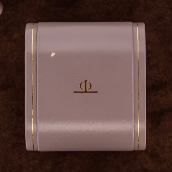 Original Baume & Mercier presentation box for the Hampton MV045120 with gold Phi emblem stamped on the lid, cream finish with gold-line trim.