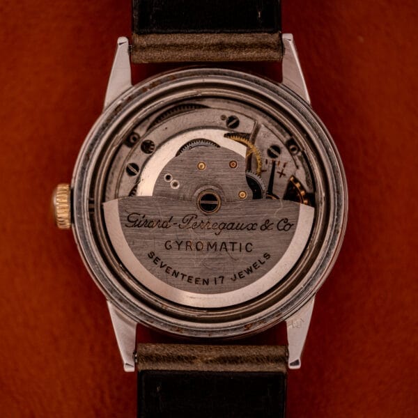 The back of the Girard Perregaux Gyromatic Black Gilt Dial Ref. 6250 Gold Capped Case showcases its intricate mechanical movement, beautifully complementing its elegant black gilt dial.