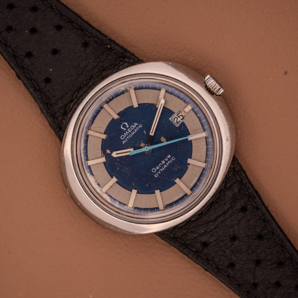 Omega Automatic Geneve Dynamic Ref. 166.107 Cal. 1421 with a bold blue and silver dial, automatic movement, and classic black leather strap.
