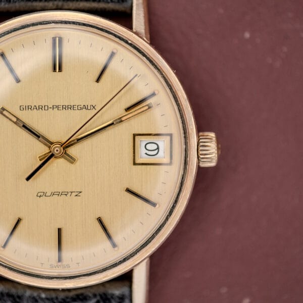 Girard Perregaux Quartz Date 3696 watch with Cal. ETA 940, champagne dial, and black leather strap.