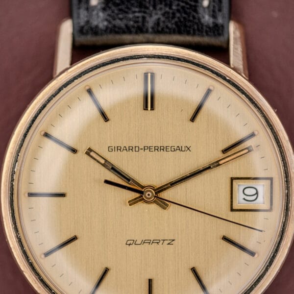 Close-up of a Girard Perregaux Quartz Date 3696 wristwatch featuring a champagne dial, black hands, and a date display at 9, powered by Cal. ETA 940.