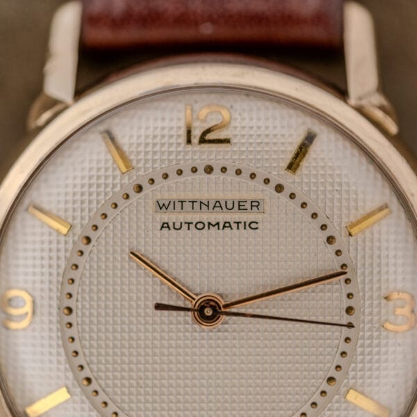 Close-up of a Wittnauer Automatic Waffle Dial Ref. 2023 with a 10k GF case, gold details, textured white waffle dial, and Cal. 11ARB movement.