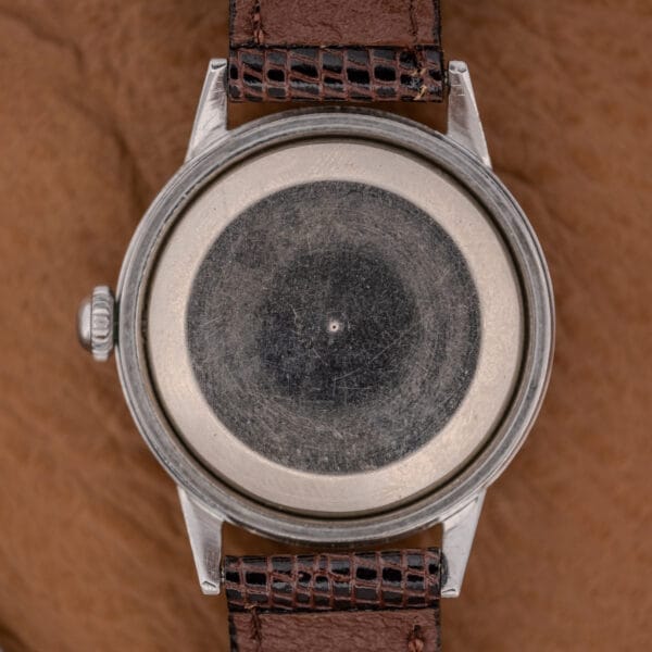 A Gruen Precision Auto-Wind Copper Dial in Stainless Steel Cal. 400 wristwatch with a worn copper dial and a brown textured leather strap, photographed from above.