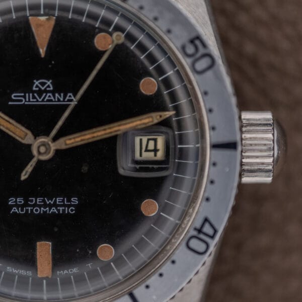 Close-up of a Silvana 25 Jewels Automatic Skin Diver Cal. 2472 with black dial, date set to 14, and silver bezel showing numerals 40 and 50.