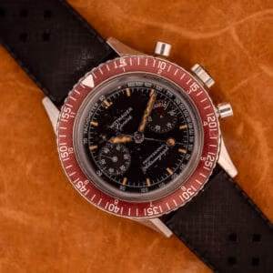 Vintage Wittnauer Professional Chronograph Ref. 7004A top-down view with burgundy bezel, matte black dial, and aged tritium indices.