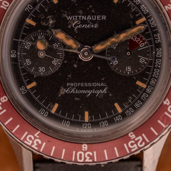 Close-up of a Wittnauer Professional Chronograph Ref. 7004 Landeron 248, featuring a red bezel and worn hands, powered by the iconic Landeron 248 movement.