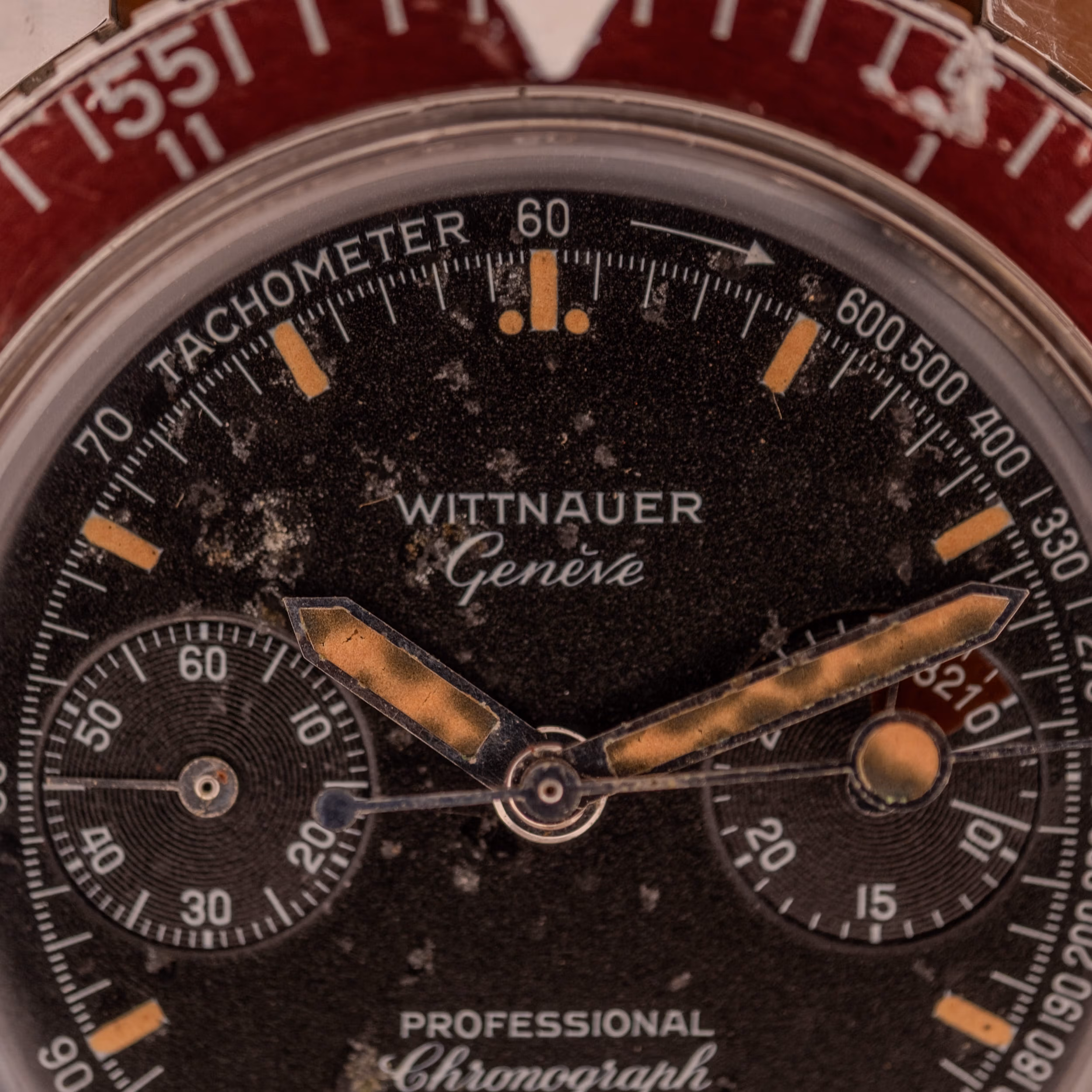 Wittnauer 7004A dial close-up showing applied baton indices, broad sword hands, and caramel-aged tritium lume against matte black.
