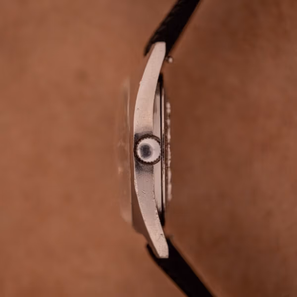Side profile of Aquastar 1701 Skin Diver case showing signed crown with star inset, domed acrylic crystal, and honest polishing wear on the steel flank.