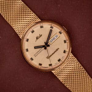 The Mido Commander Automatic Datoday Ref. 8429 features a Milanese strap, beige dial, and an automatic Datoday display showing SAT 30.