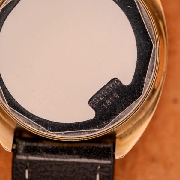 Close-up of the Mido Automatic Multi Star Datoday Cal. 1819 Ref. 6929300 watch back cover with engraved numbers and caliber details on its metal surface.