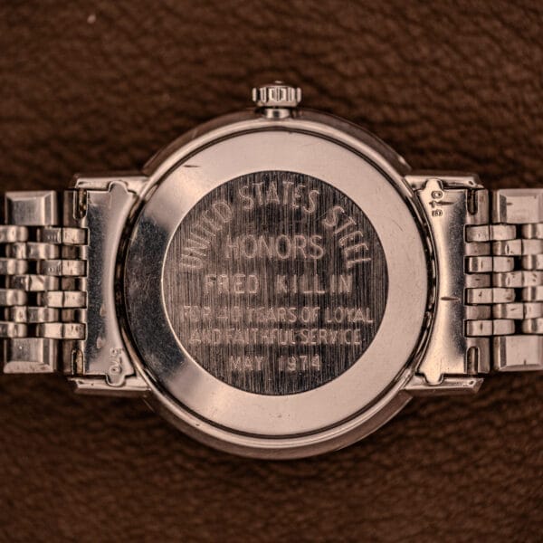 Close-up of the Omega Automatic Ref. 166.020 for U.S. Steel Presentation Watch, featuring a commemorative caseback engraving for 15 years of service to United States Steel.