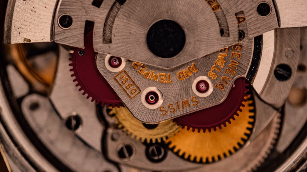 Close-up of Rolex watch gears and mechanical parts, showcasing intricate details and engraved SWISS text—a guide for spotting authentic serial numbers.
