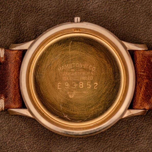 Close-up of the inside case back of a Hamilton Thin-O-Matic Black Dial 10k Gold Filled Case Cal. 663, showing engraved serial numbers and text that highlight its gold-filled construction.