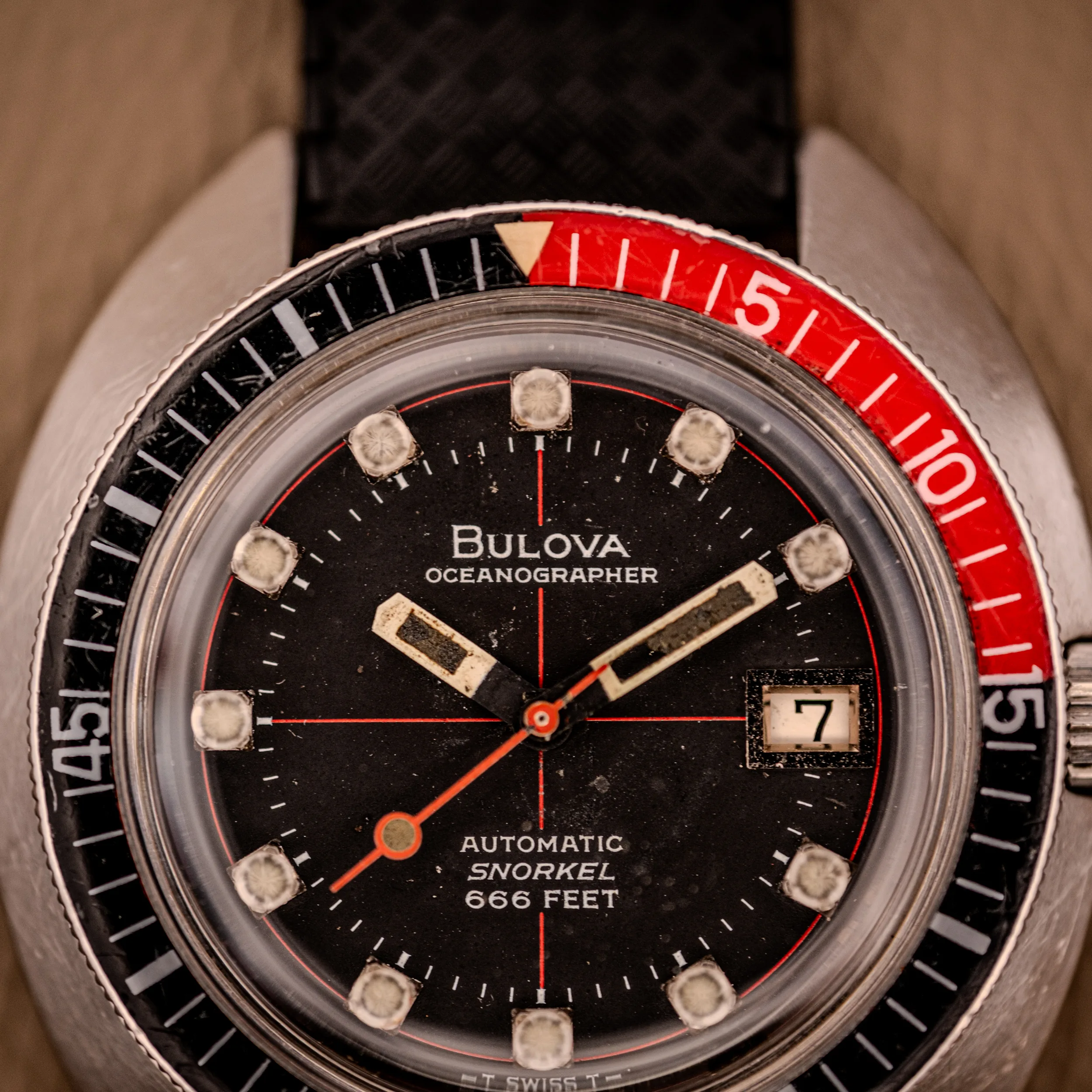 Close-up of the Bulova Oceanographer Automatic Snorkel 714 with its Red Cross Hair Dial, showing the hands and date at 3 o’clock—spotlighting this watch’s distinctive and classic design.