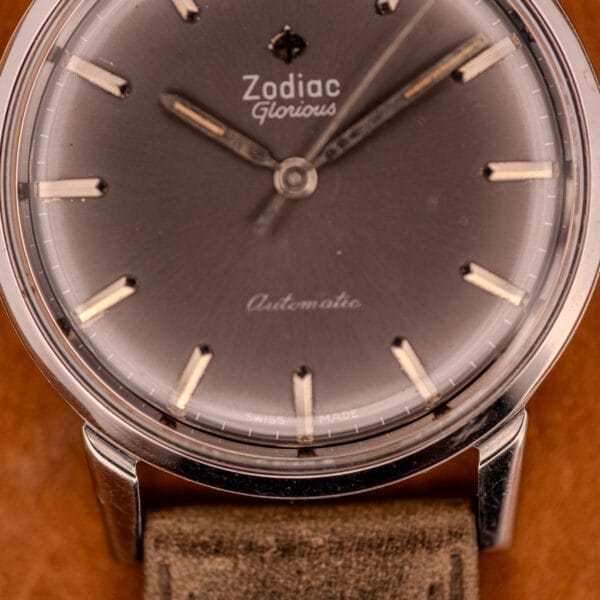 Close-up of the Zodiac Glorious Automatic Ref. 702-917, featuring a stainless steel case, Cal. 70-72 movement, and a brown leather strap.