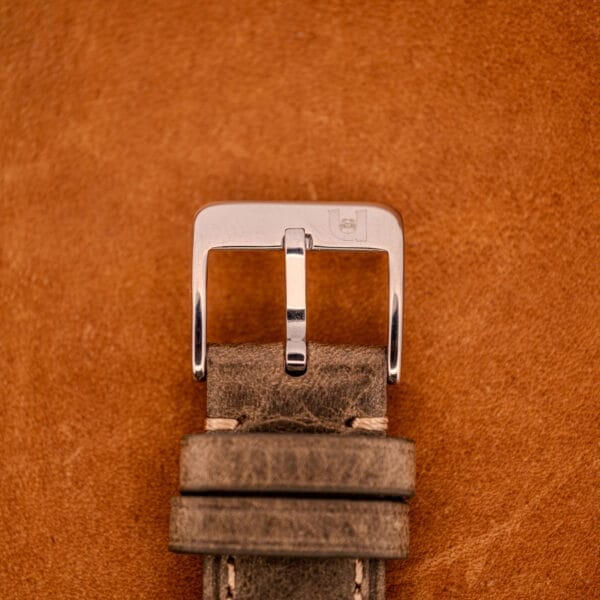 Close-up of a Zodiac Glorious Automatic Ref. 702-917 Stainless Steel Cal. 70-72 watch buckle on textured brown leather.