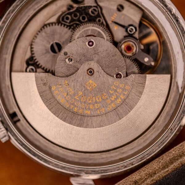 Close-up of a Zodiac Glorious Automatic Ref. 702-917, showcasing the Cal. 70-72 movement with visible gears, screws, and engraved text on stainless steel components.