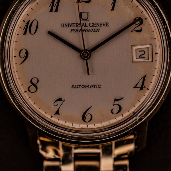 Close-up of a Universal Geneve Polerouter Date with Arabic numerals dial, automatic Cal 215 movement, time at 12:11, and date window at 3 o’clock.