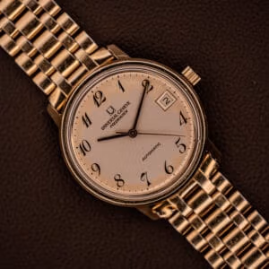 Universal Geneve Polerouter Date front view, cream dial with black Breguet Arabic numerals, 10K gold-filled case on signed beads-of-rice bracelet