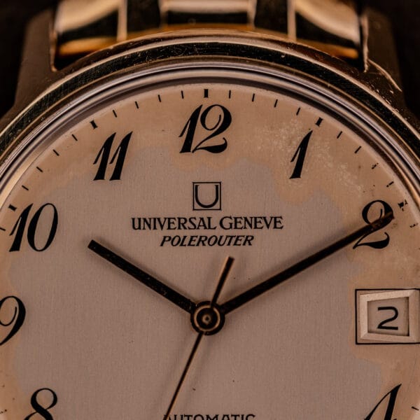 Close-up of a Universal Geneve Polerouter Date Arabic Numerals Dial Automatic Cal 215 watch showing the time at 10:10 and a visible date window.