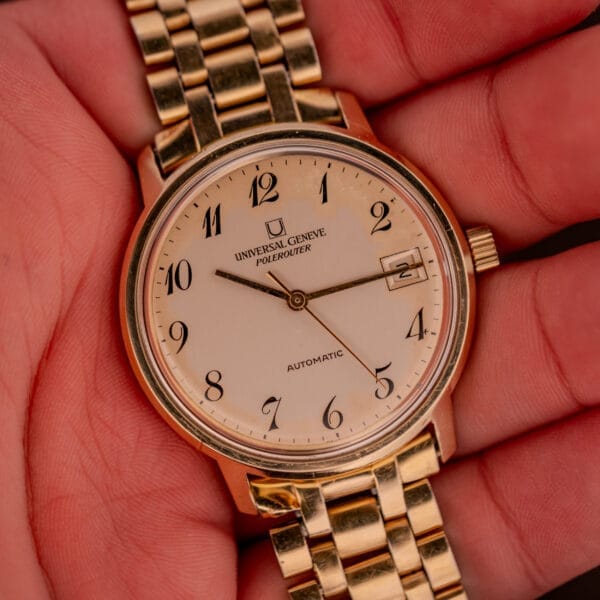 Universal Geneve Polerouter Date Arabic Numerals Dial Automatic Cal 215 wristwatch with date display, shown held in hand.