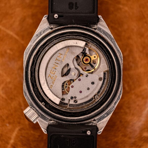 Close-up of the Zenith Automatic Defy NA.50.012.2 in Stainless Steel Cal. 2562 PC, featuring its exposed mechanical movement against a brown leather background and highlighting its refined craftsmanship.