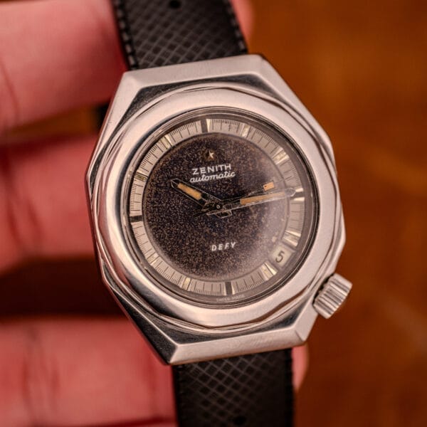 A close-up of the Zenith Automatic Defy NA.50.012.2 in stainless steel Cal. 2562 PC, showcasing a black strap and textured black dial.