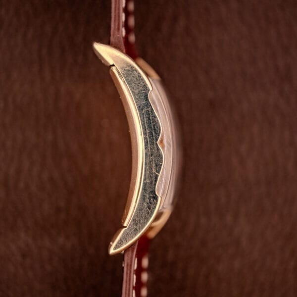 Close-up of the Gruen Curvex Precision Ref. 370-600 with a 10k gold filled case featuring textured sides, paired with a brown leather strap accented by white stitching for a touch of timeless elegance.