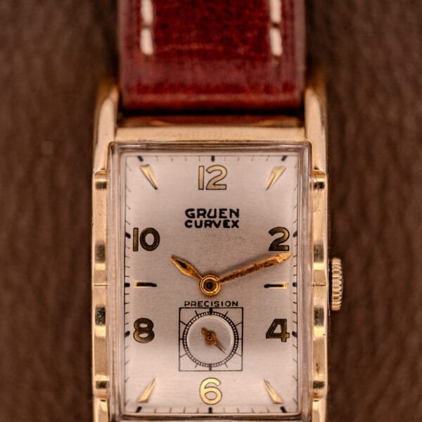 A Gruen Curvex Precision Ref. 370-600 with 10k Gold Filled rectangular case and brown leather strap, displaying 2:20.