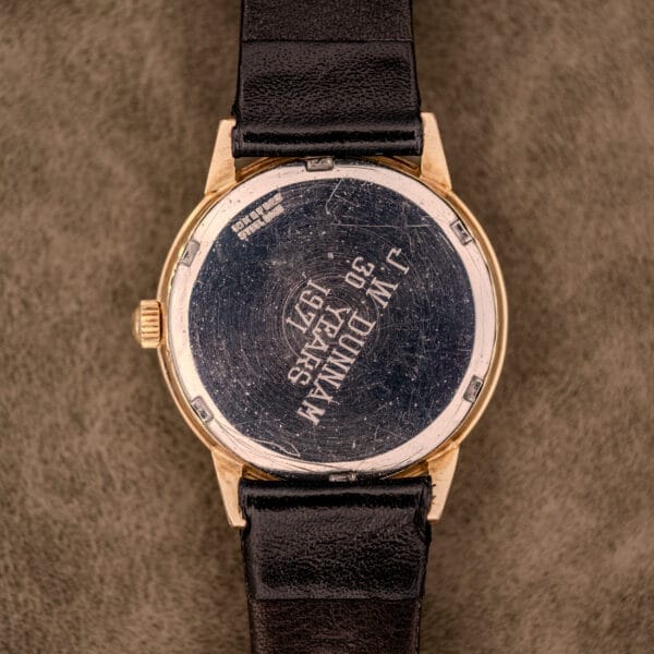 An Omega Automatic Ref. LU 6304 "HF" Logo Dial with a 10k GF bezel and leather band, featuring an engraved metal case back that shows visible scratches.