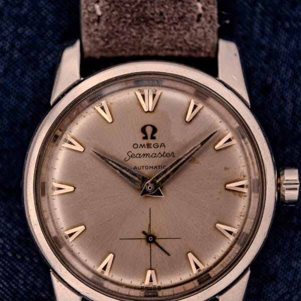 Close-up of an Omega Automatic Seamaster 2846-2848 wristwatch in stainless steel, showcasing a sunburst dial.