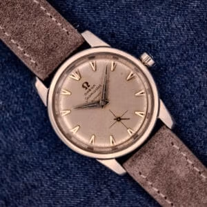 An Omega Automatic Seamaster 2846-2848 Stainless Steel watch with a sunburst dial, stylishly presented on blue denim fabric.