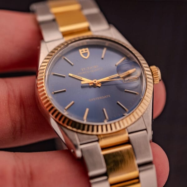 A close-up of the Tudor Prince-Quartz Oysterdate Ref. 9150, showcasing its striking two-tone blue dial and gold and silver bracelet.