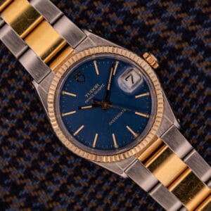 The Tudor Prince-Quartz Oysterdate Ref. 9150 Two-Tone Blue Dial boasts a stylish blue dial and an elegant gold-silver metal band.