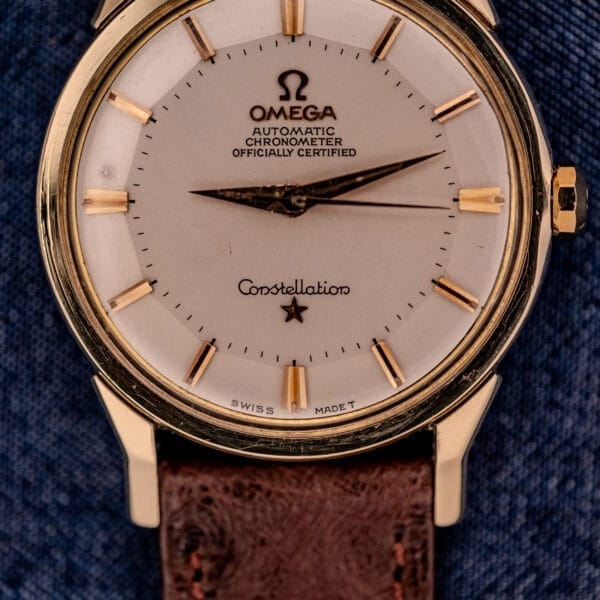 Close-up of an Omega Constellation Pie-Pan Dial Ref. 167.005, showcasing a 14k gold capped case and brown leather strap.