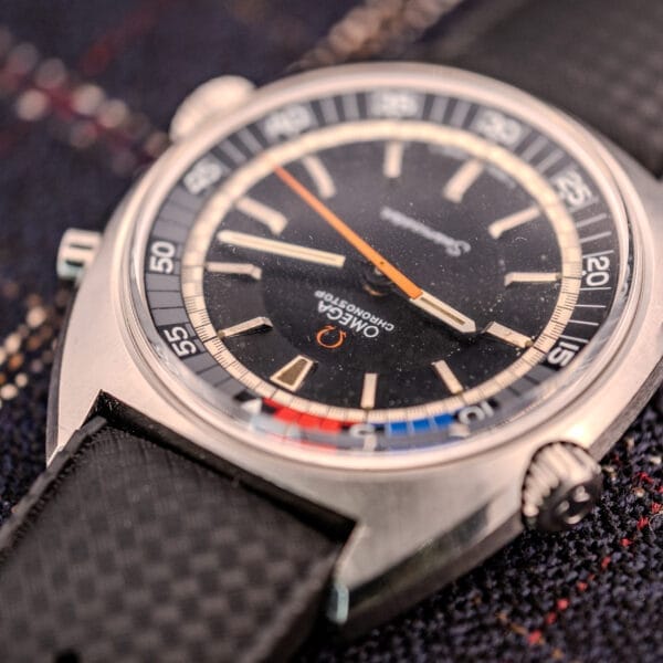 Close-up of an Omega Seamaster Ref. 145.008 Chronostop Regatta wristwatch, featuring a Cal. 865 movement, black strap, and detailed dial markings.