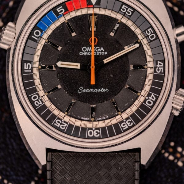Close-up of an Omega Seamaster Ref. 145.008 Chronostop Regatta featuring a black dial, colorful bezel segments, and powered by the Cal. 865 movement.