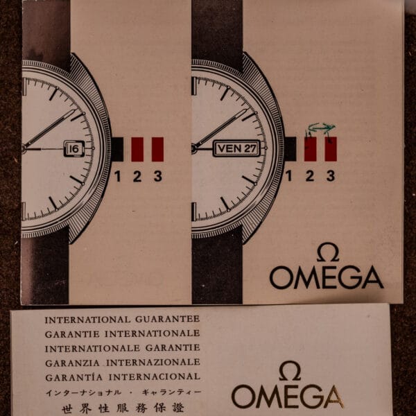 Close-up of Omega Constellation Chronometer Ref. 168.045 Day/Date Full Set guarantee cards with partial watch face and multilingual chronometer warranty text visible.