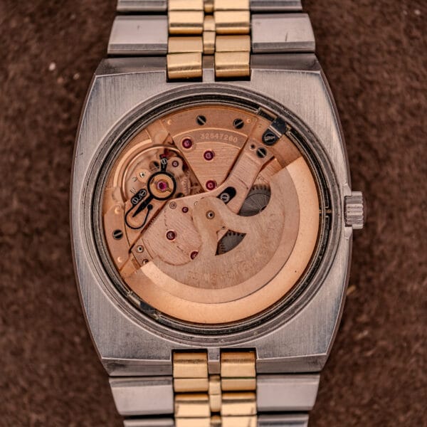 Close-up of the Omega Constellation Chronometer Ref. 168.045 Day/Date Full Set’s exposed mechanical movement, highlighting precision gears, chronometer certification, and an eye-catching two-tone bracelet.