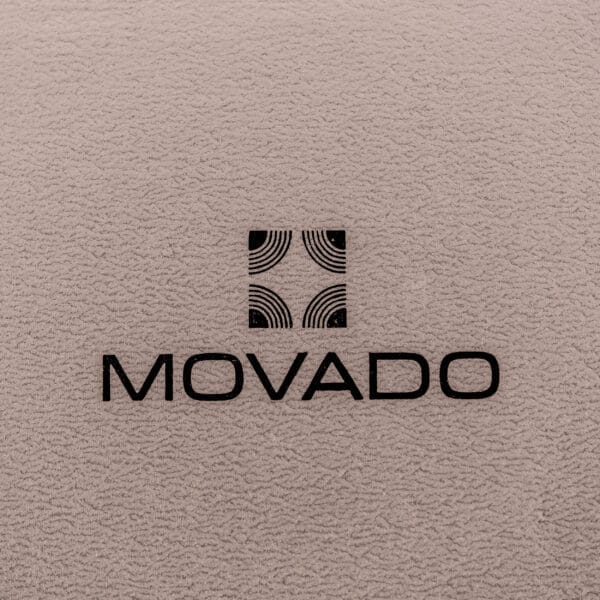 Movado logo with geometric square design on a textured beige background, inspired by the precision of the Movado / Zenith Electronic Tuning Fork Cal ESA 1962 Box & Papers.