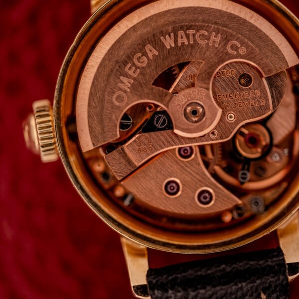 Close-up of the Omega Ladymatic Sunburst Dial Ref. W 5294, featuring its exposed Cal. 680 movement with visible gears, fine engravings, and radiant sunburst dial detailing.