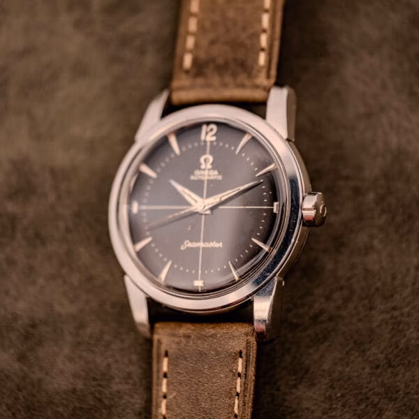 Front-on view of the Omega Seamaster Ref. 2848 showing applied silver indices, Arabic 12, and the cursive Seamaster script above six
