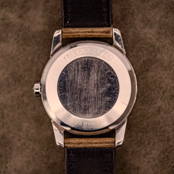 Caseback exterior of the Omega Seamaster Ref. 2848 engraved SEAMASTER and WATERPROOF showing honest brushed-steel patina from decades of wear