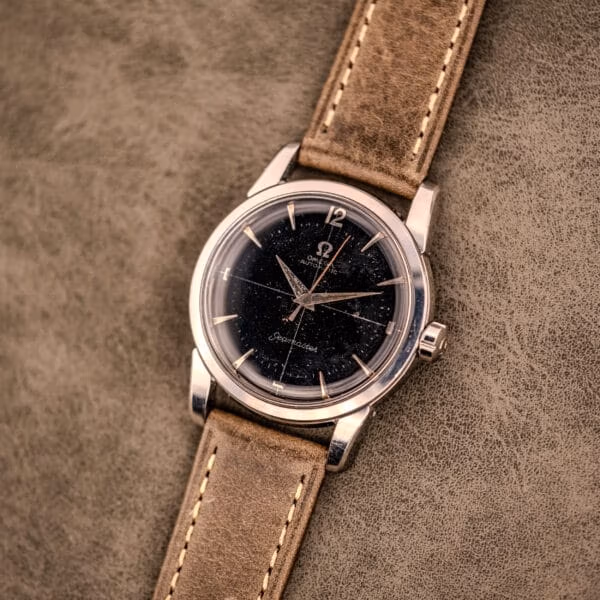 Vintage Omega Seamaster Ref. 2848 black dial watch with olive distressed leather strap and stainless steel case shown front-on