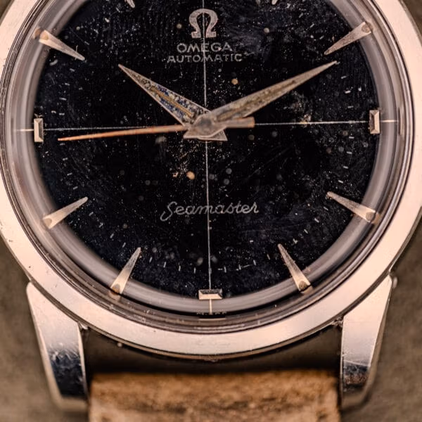 Original factory black dial of an Omega Seamaster Ref. 2848 showing intact crosshair, applied Arabic 12, and aged caliber 500 patina