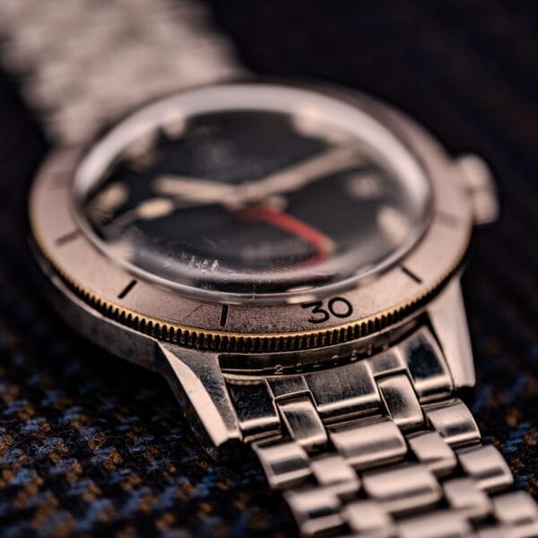Close-up of the Zodiac Aerospace GMT Ref. 752-934 with a black dial, chrome bezel showing the number 30, and metal band.
