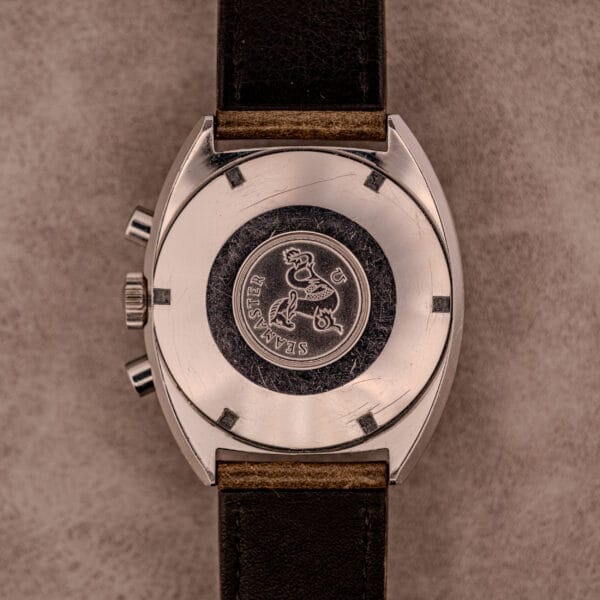 A close-up of the back of an Omega Seamaster Chronograph Ref. 145.016 Reverse Panda Dial wristwatch with a black leather strap and the Seamaster logo engraved.