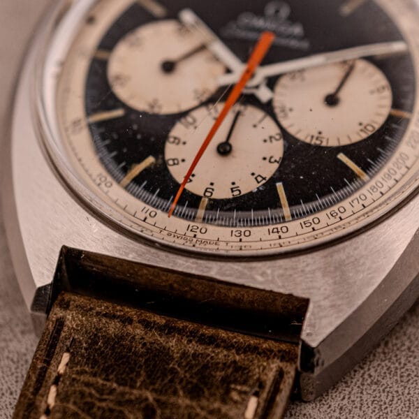 Close-up of an Omega Seamaster Chronograph Ref. 145.016 with a reverse panda dial, three subdials, and a brown leather strap.