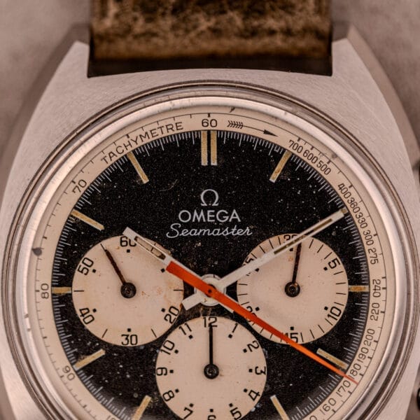 Close-up of an Omega Seamaster Chronograph Ref. 145.016 with a reverse panda dial, featuring three subdials and a tachymeter scale on the bezel.