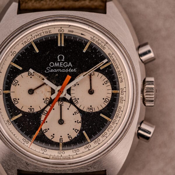 Close-up of the Omega Seamaster Chronograph Ref. 145.016 with a reverse panda dial, three subdials, and an orange second hand.